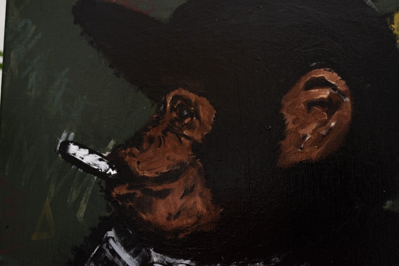 A close-up of a raw, painterly oil or acrylic artwork. It shows the profile of a chimpanzee or monkey with black fur, a reddish-brown ear and snout, and a dark cap. The monkey is smoking what appears to be a cigarette or cigar. The background is a dark, army green or brown color.